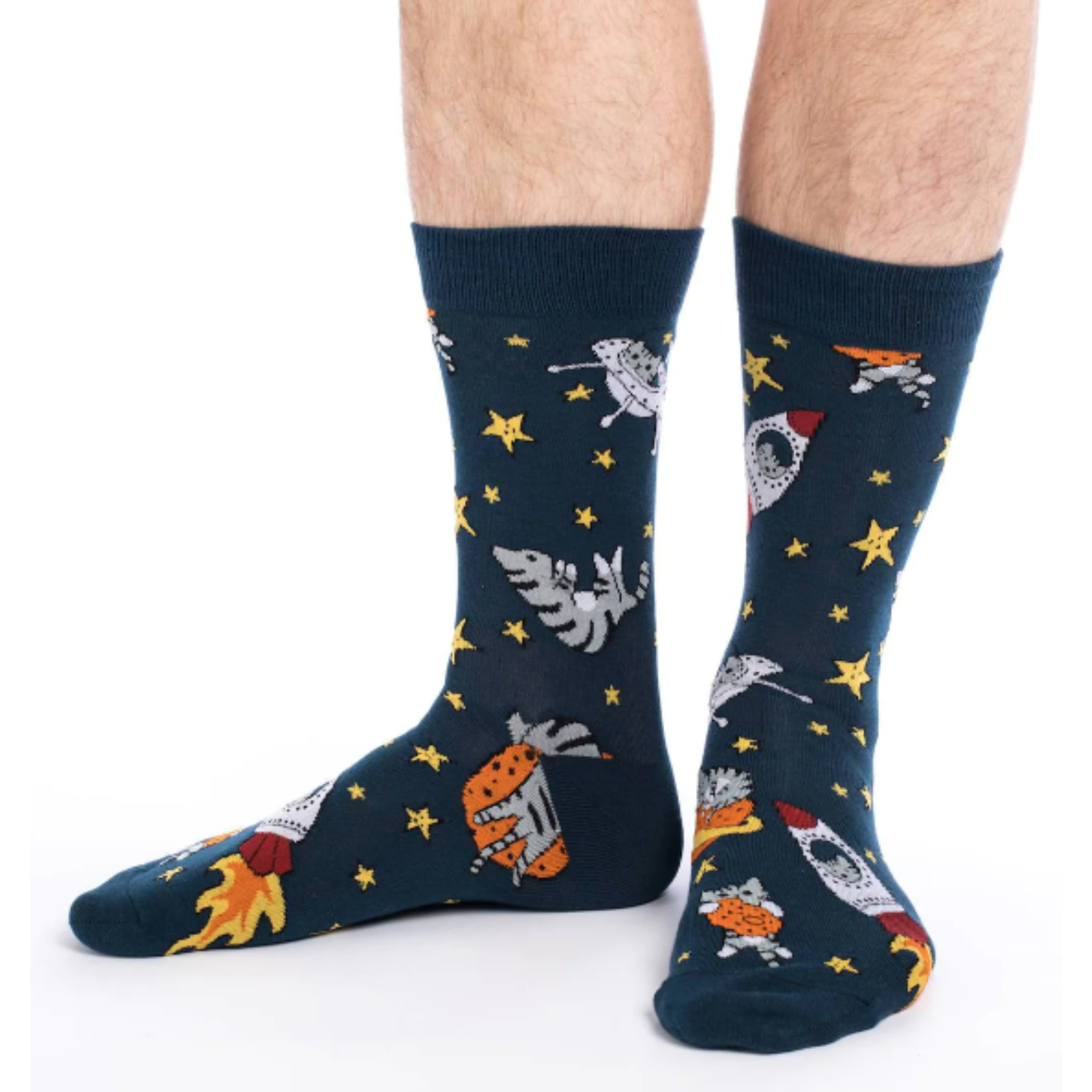 Good Luck Sock Space Cat men's crew sock featuring navy blue sock with cats and stars and rocket ships all over. Show on model's feet. 