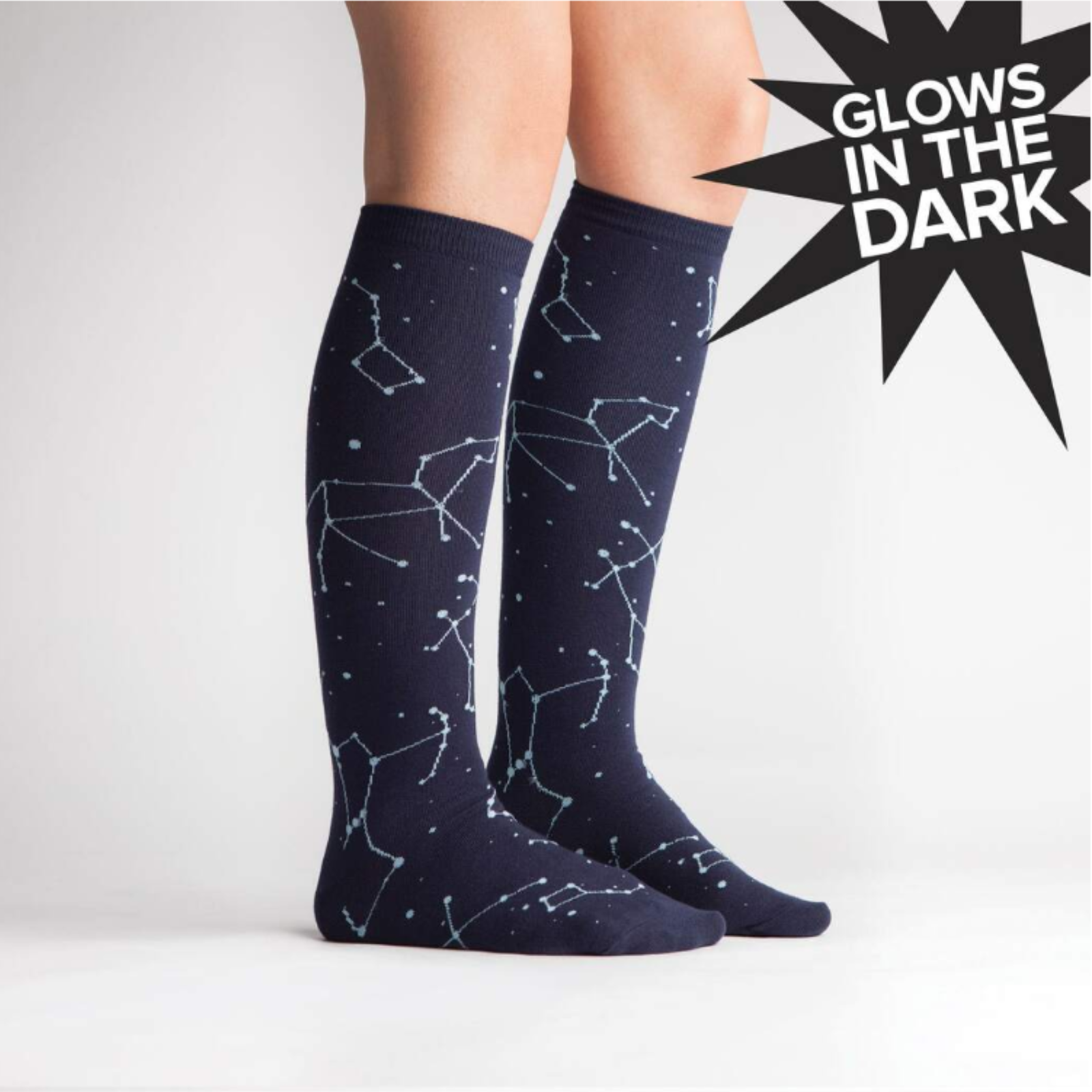 Sock It To Me Constellation (GLOWS IN THE DARK!) women's knee high sock. Featuring navy blue sock with constellations all over. Socks worn by model. 