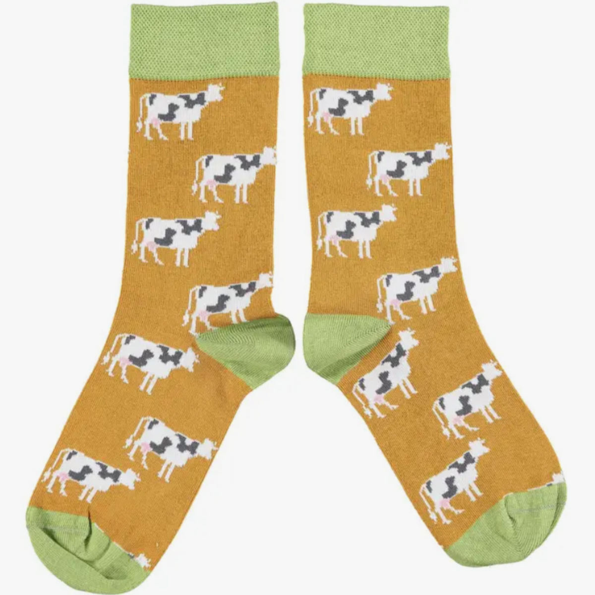 Catherine Tough Cow cotton women&#39;s crew socks featuring black and white cows on a ginger background with light green cuff, heel and toe