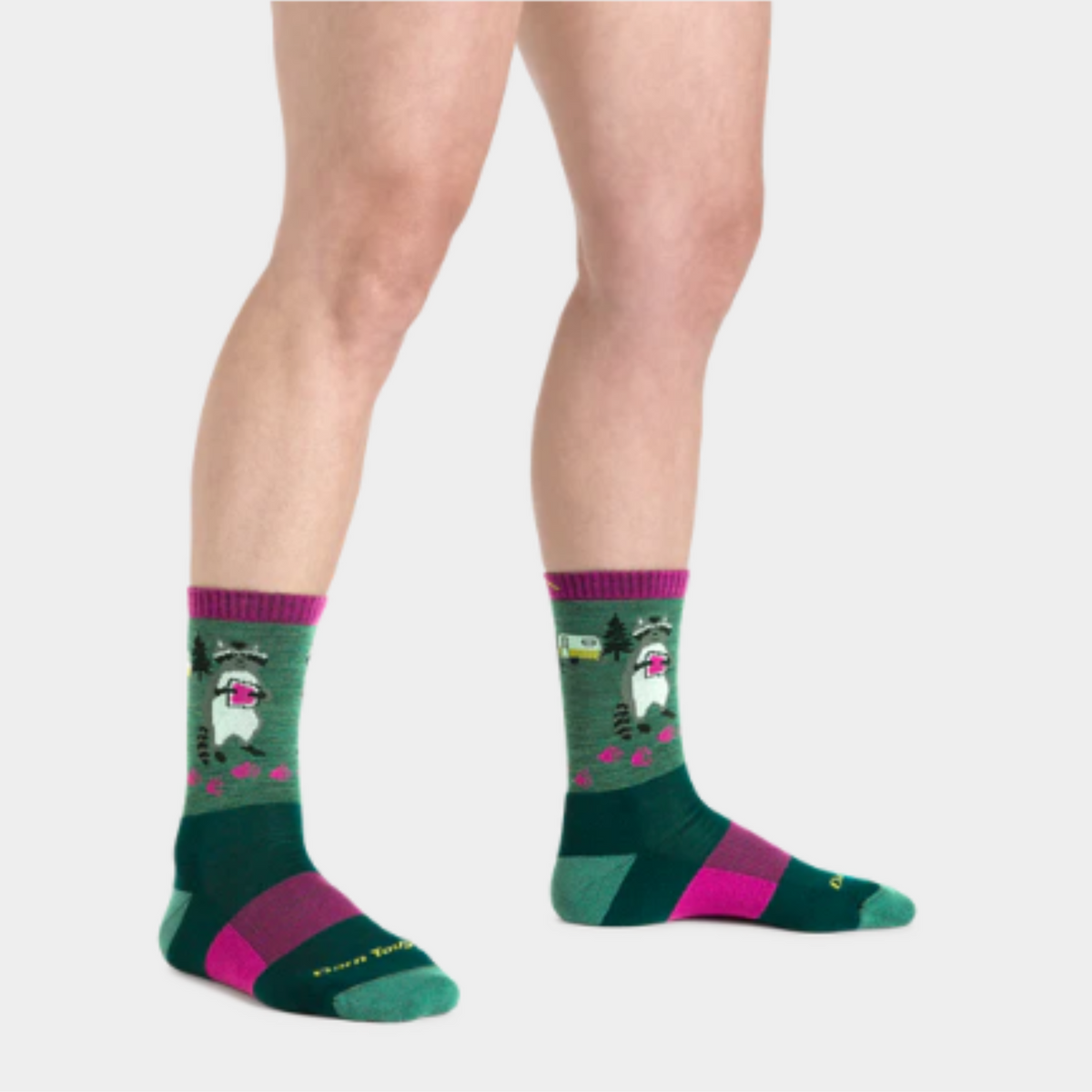 Darn Tough 5001 Critter Club Micro Crew Lightweight Hiking Women&#39;s Sock featuring green sock with purple cuff and raccoon holding jam sandwich. Sock shown on model&#39;s feet..