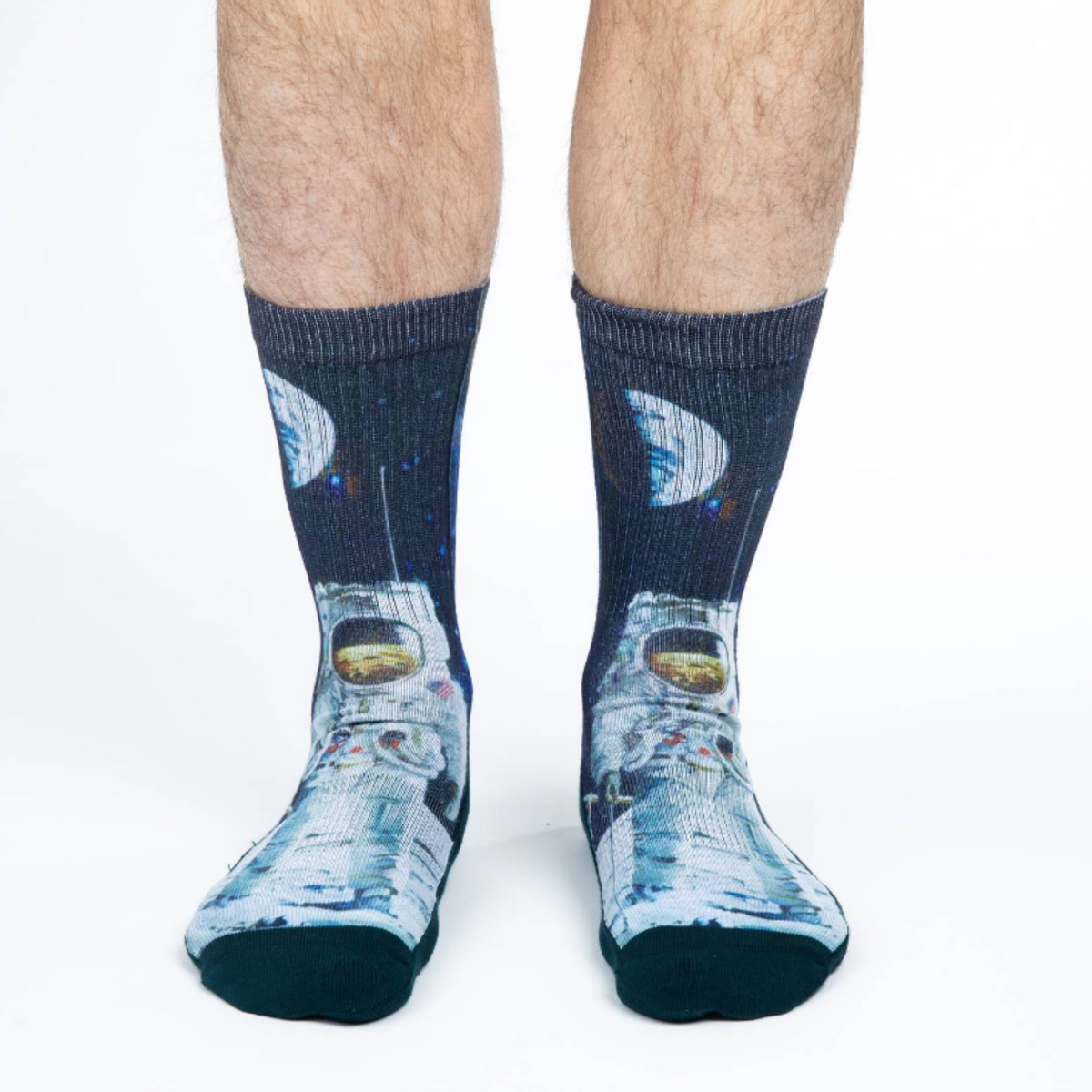 Good Luck Sock Apollo Astronaut men&#39;s crew sock featuring black sock with image of Apollo astronaut on the moon. Socks shown on model&#39;s feet. 