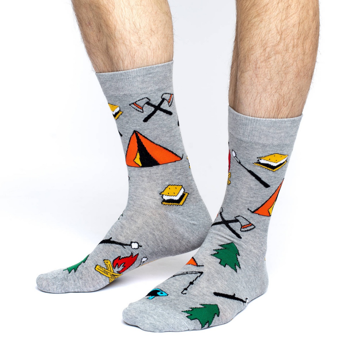 Good Luck Sock with images of Camping men&#39;s gray crew sock featuring tent, tree, smores, and campfire on model&#39;s feet