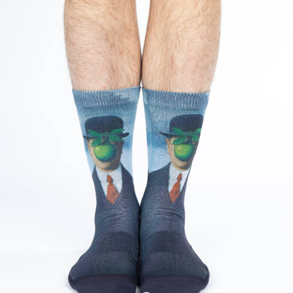 Good Luck Sock The Son of Man men&#39;s crew sock featuring painting &quot;Son of Man&quot;. Socks shown on model&#39;s feet. 