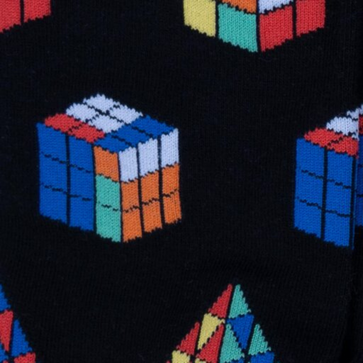Detail of Sock It To Me Puzzle Box men&#39;s sock featuring black sock with cube color match puzzle game worn