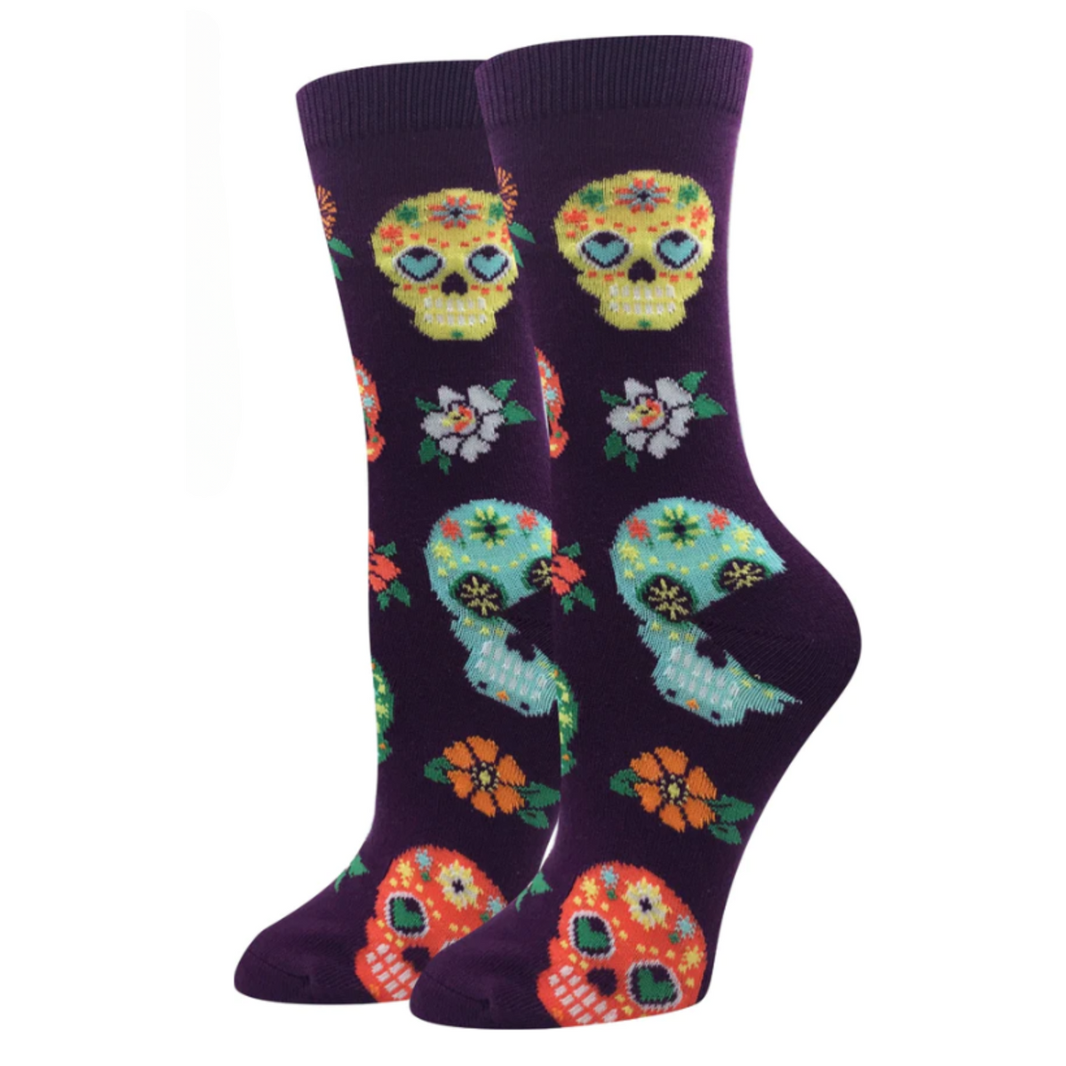 Sock Harbor Calaveras women&#39;s crew sock featuring purple sock with orange, yellow, and teal Sugar Skulls for the Day of the Dead. Socks shown on display feet from the side. 