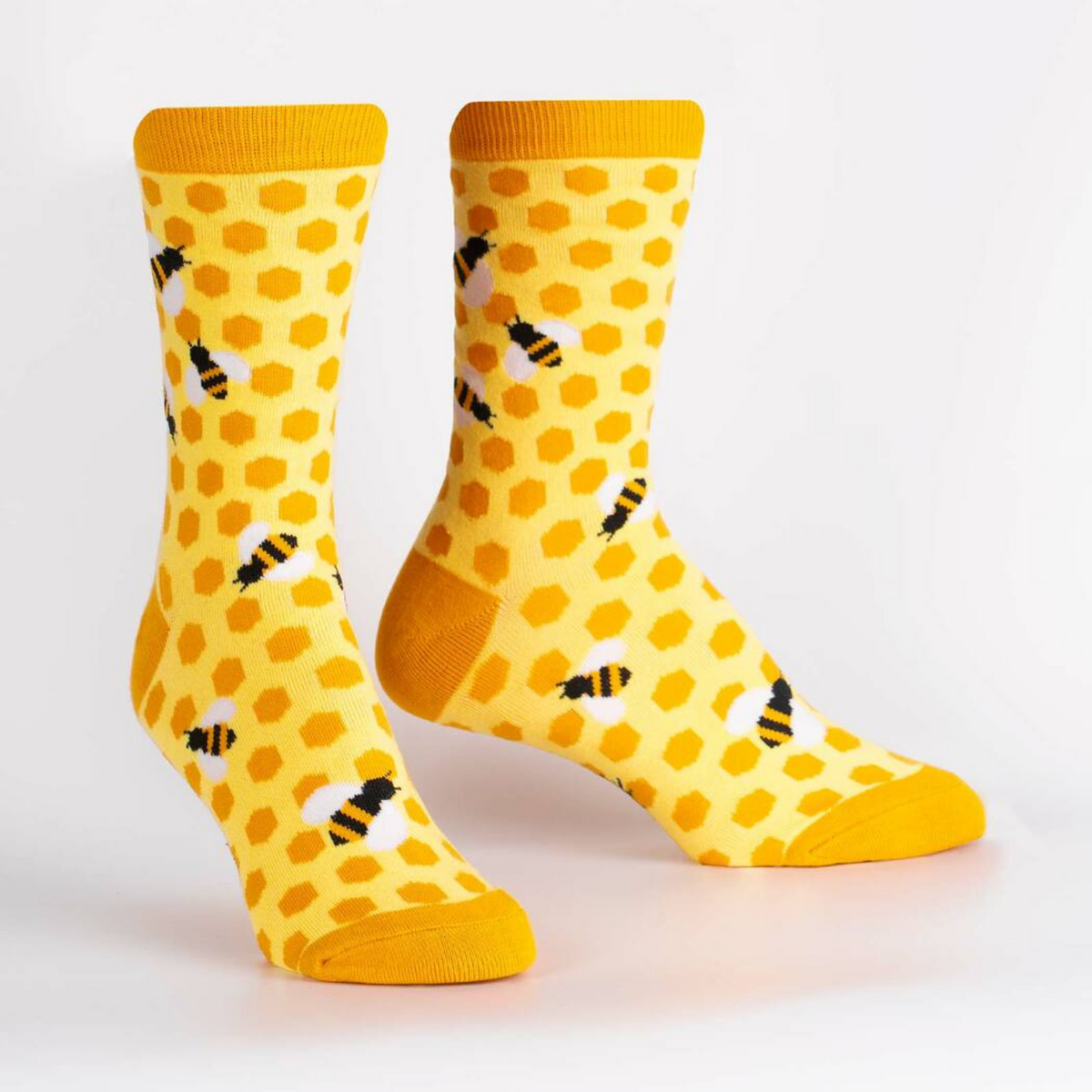 Sock It To Me women&#39;s yellow sock Bees Knees featuring honeycomb and bees all over on display feet