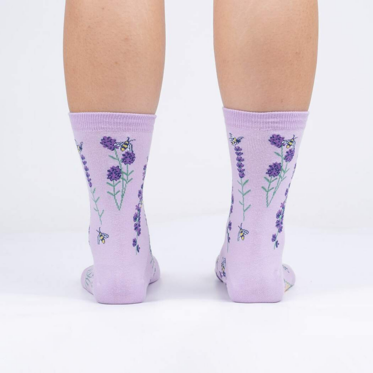 Sock It To Me Bees and Lavender women&#39;s socks featuring lavender socks with bees and lavender flowers all over worn by model from back