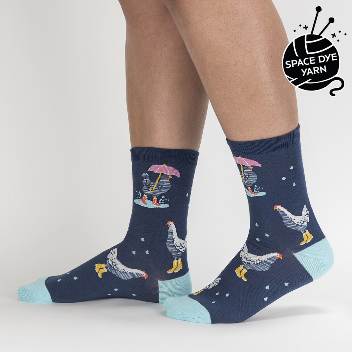 Sock It To Me Chicken Little women&#39;s crew sock featuring blue sock with light blue heel and toe with chickens in the rain all over. Socks worn by model seen from side. 