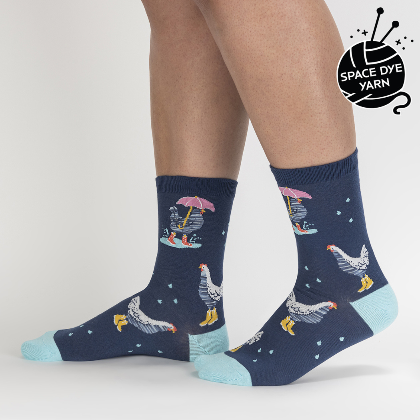 Sock It To Me Chicken Little women's crew sock featuring blue sock with light blue heel and toe with chickens in the rain all over. Socks worn by model seen from side. 