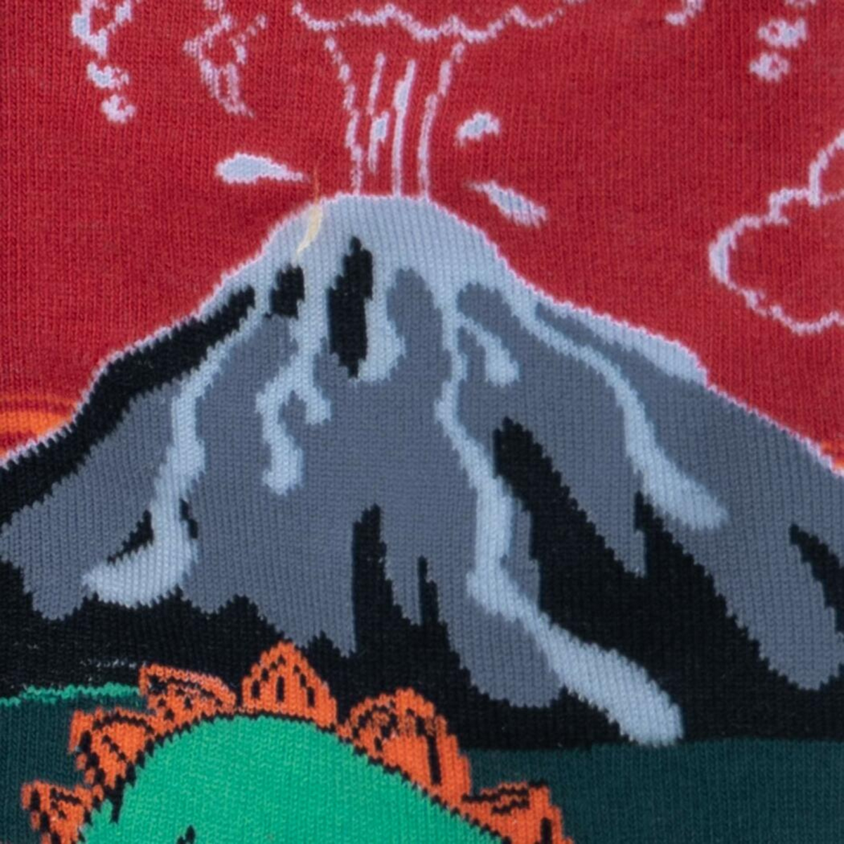 Detail of Sock It To Me Dinosaur Days men&#39;s crew socks featuring red and green socks with glow in the dark exploding volcanoes and dinosaurs. 