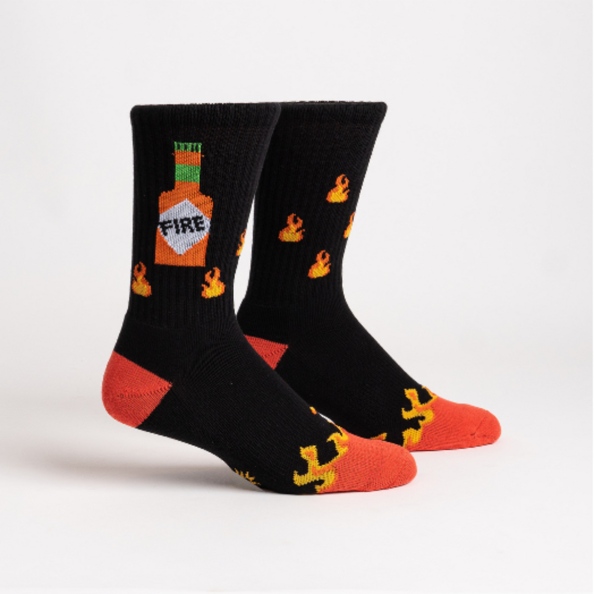 Sock It To Me Fire athletic crew men&#39;s sock featuring black socks with an image of flames and hot sauce bottle. Socks shown on display feet from side. 