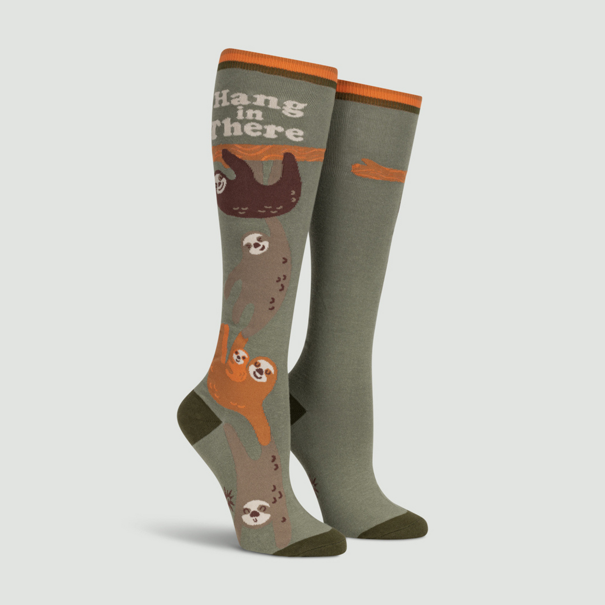 Sock It To Me Hang in There women&#39;s sock featuring brown socks with sloths and the saying &quot;hang in there&quot; on display feet