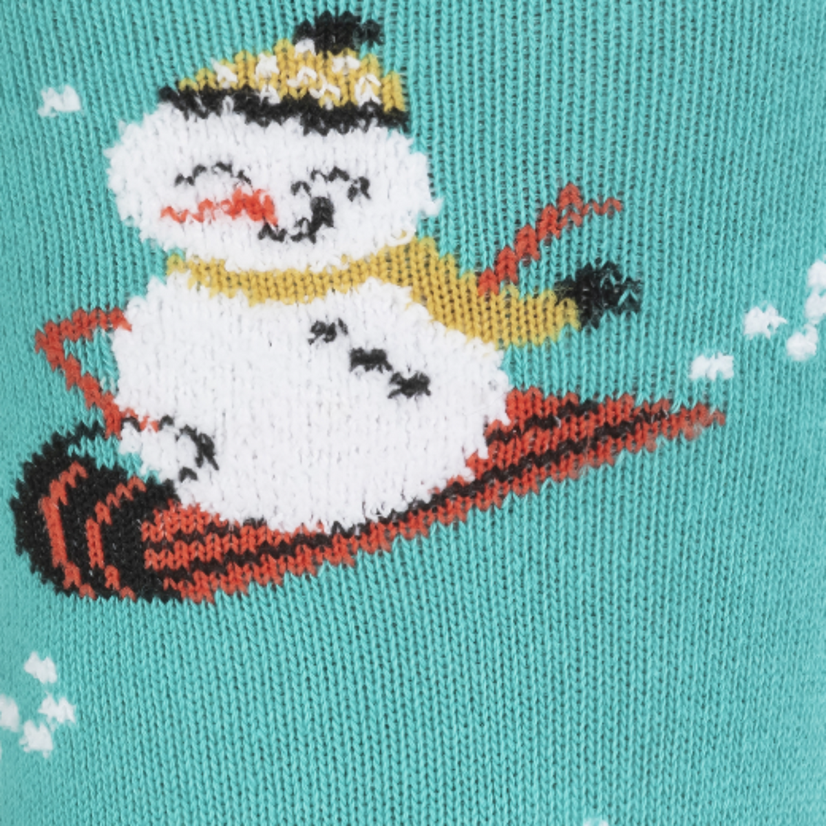 Detail of snowman on a sled on Sock It To Me Having Snow Much Fun women&#39;s crew sock featuring teal sock with smiling snowmen and white cat all over. 