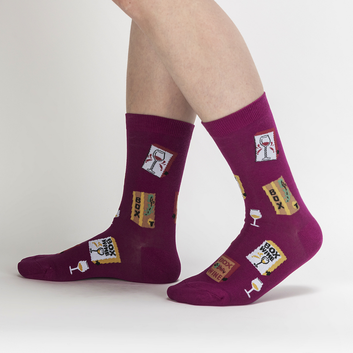 Sock It To Me It&#39;s Wine Time women&#39;s sock featuring purple sock with wine glasses and boxes of wine all over worn by model seen from side