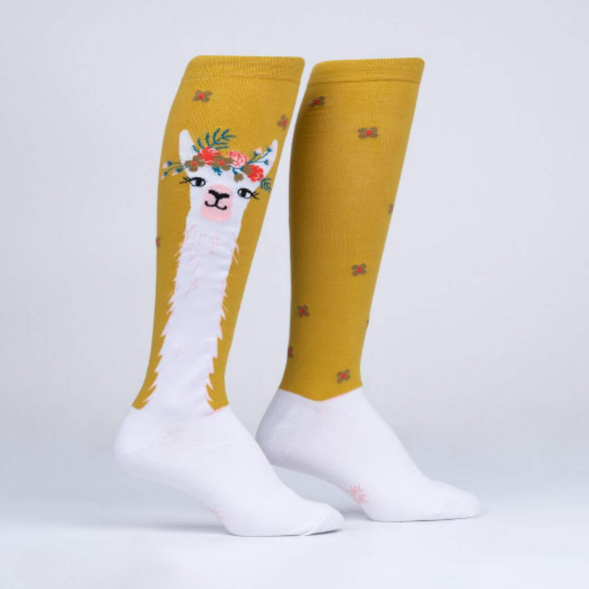 Sock It To Me Llama Queen women&#39;s sock featuring goldenrod knee high sock with white llama wearing a floral crown. Socks shown on display feet from side. 