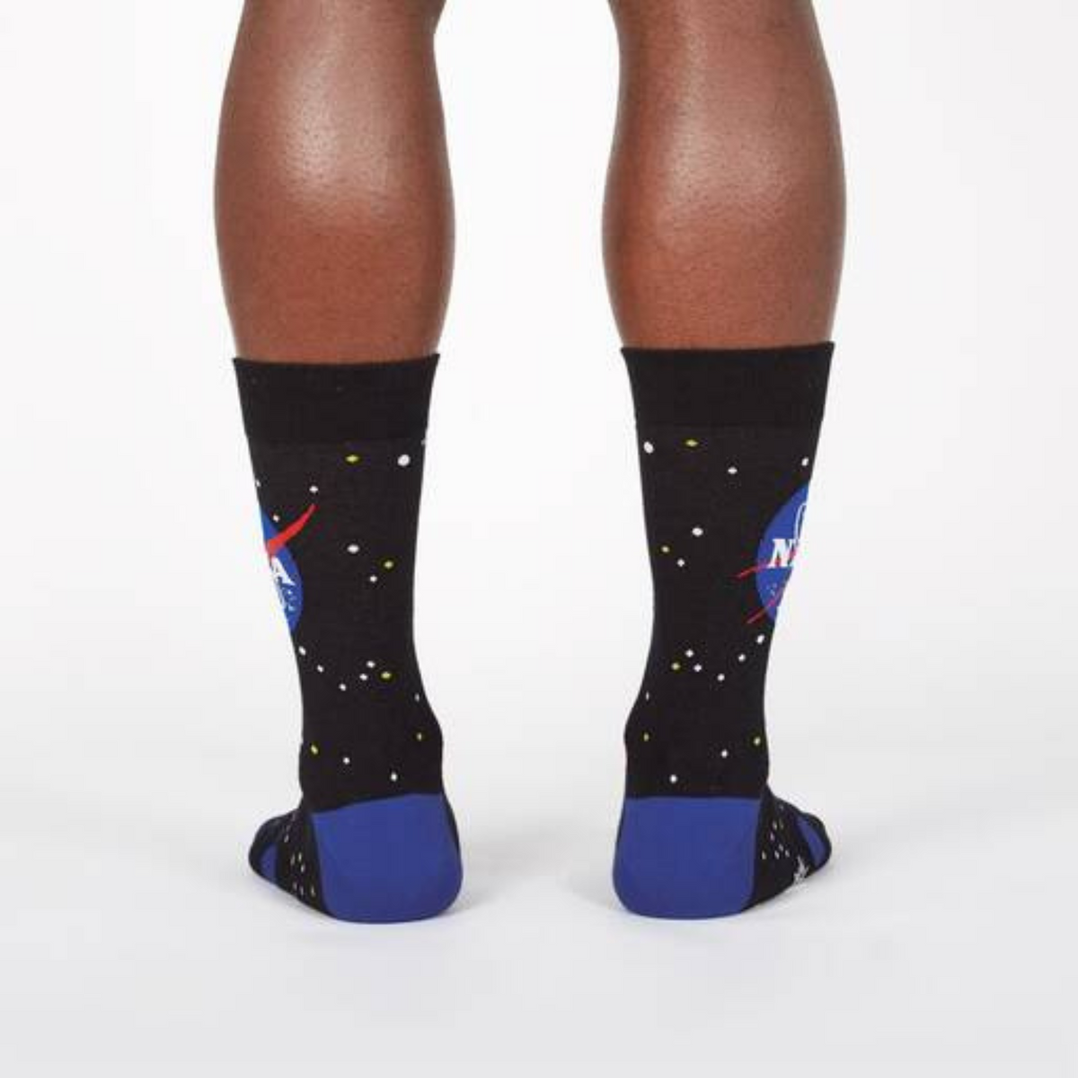 Sock It To Me NASA Solar System men&#39;s crew socks featuring black sock with NASA logo and planets all over. Socks worn by model seen from behind. 