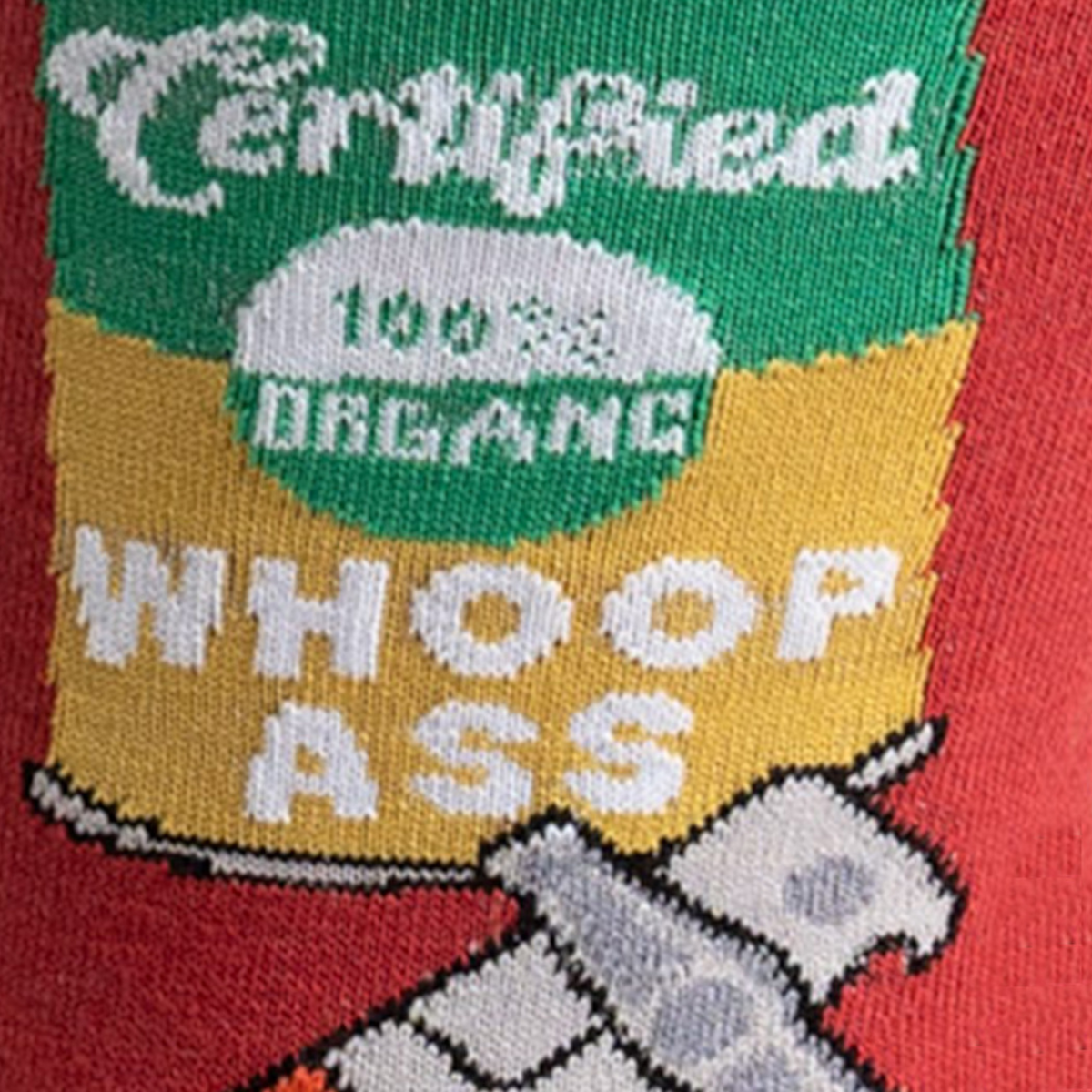 Sock It To Me Opening Up A Can men&#39;s sock featuring red crew sock with can of soup labeled &quot;Certified 100% Organic Whoop Ass&quot; with can openers all over detail of can