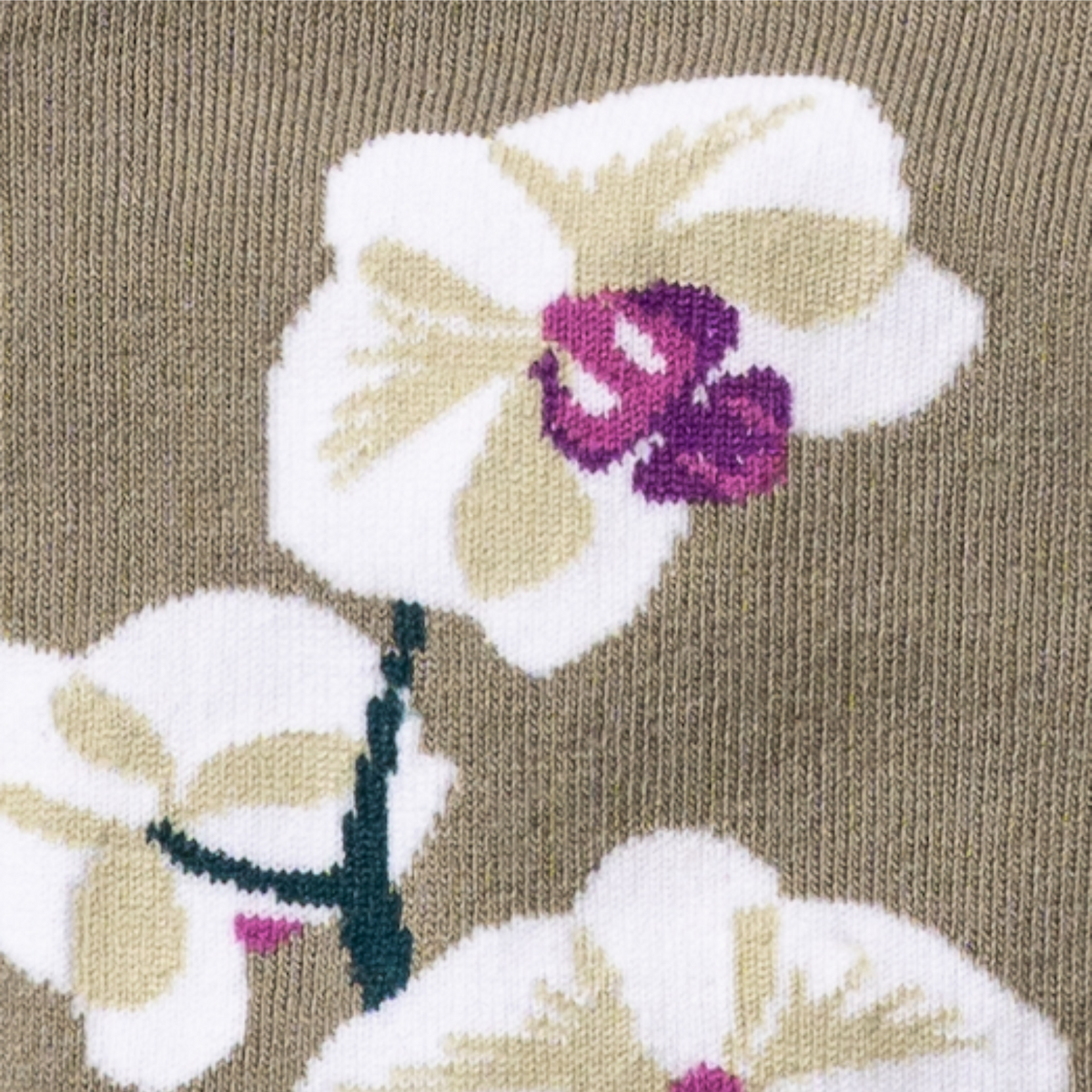 Detail of flower on Sock It To Me Orchids women&#39;s knee high sock featuring beige sock with white orchid the length of the sock.