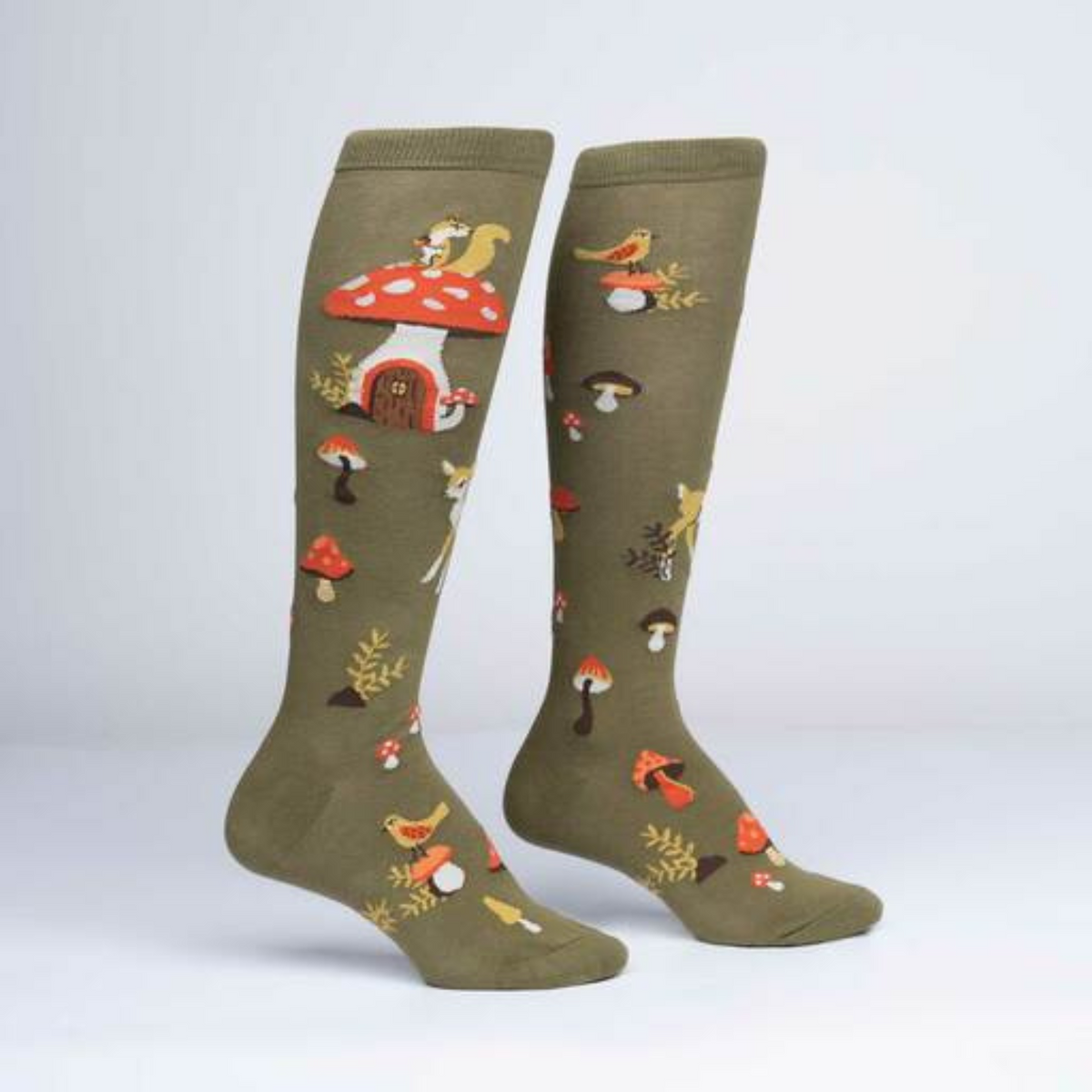 Women&#39;s Sock It To Me Shroom and Board women&#39;s and kids&#39; sock featuring green knee high with deer, squirrel, and mushrooms all over on display feet