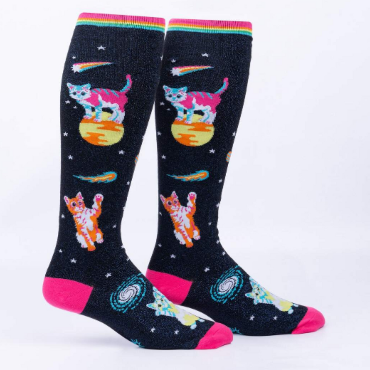 Sock It To Me Space Cats extra-stretchy knee sock featuring pink toe and heel with shimmery black background and kittens in outer space. Socks on display feet seen from side. 