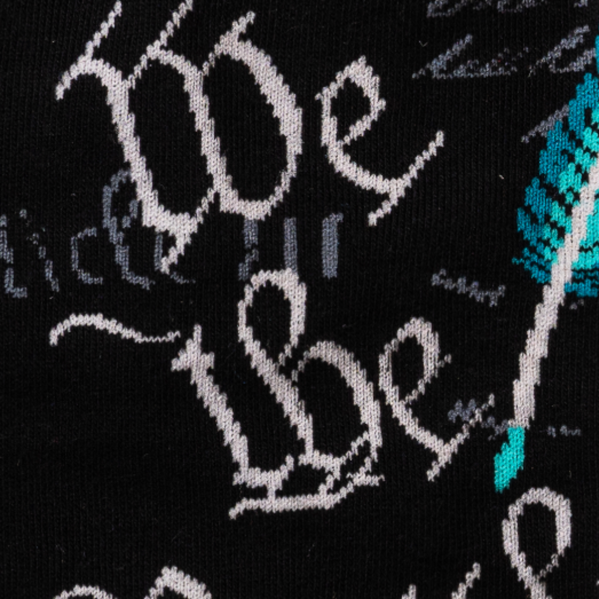 Detail of Sock It To Me The Constitution men&#39;s crew sock featuring &quot;We the People&quot; from the US Constitution on a black background. 