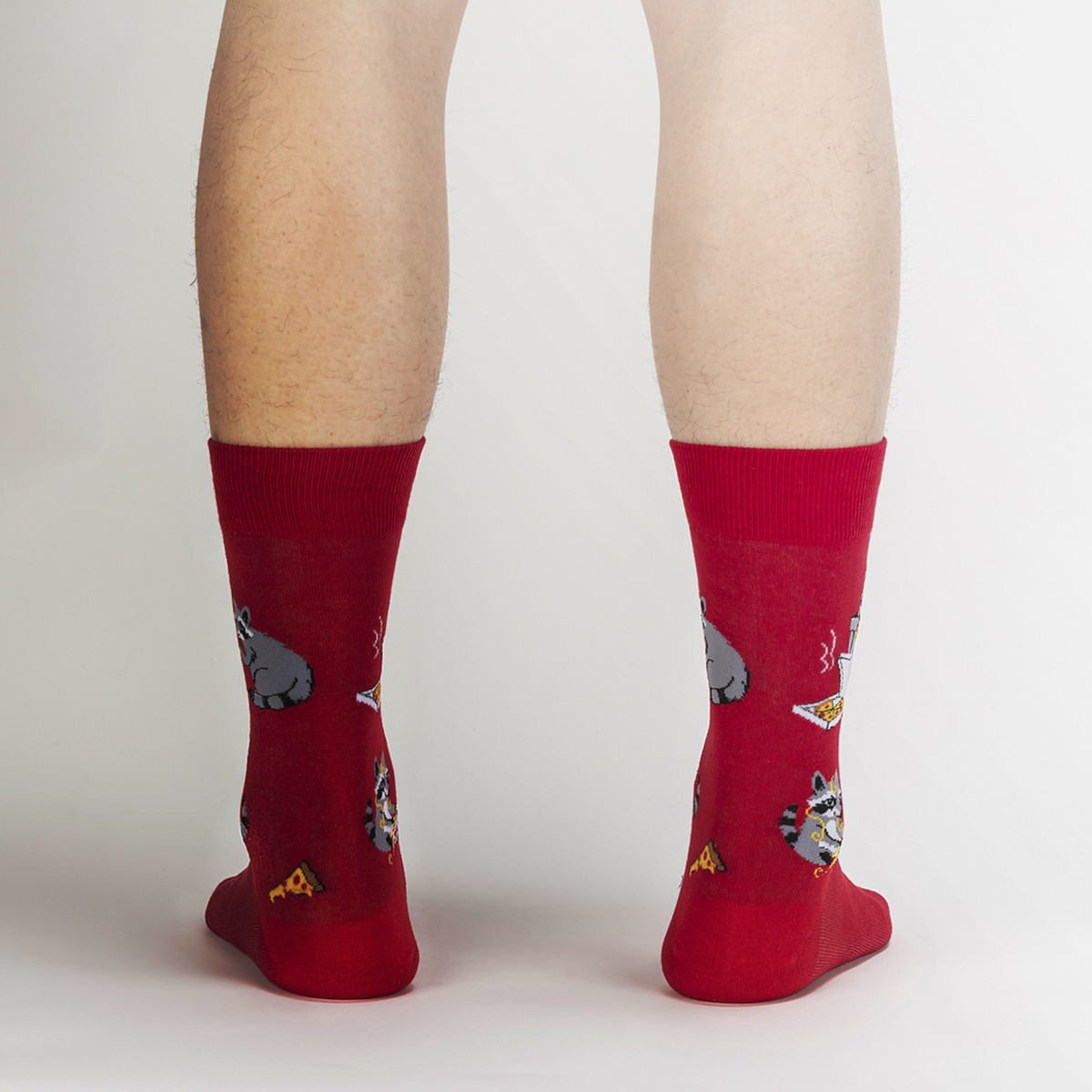 Sock It To Me Trash Panda men&#39;s sock featuring red crew sock with raccoons eating pizza out of the trash worn by a model seen from the back