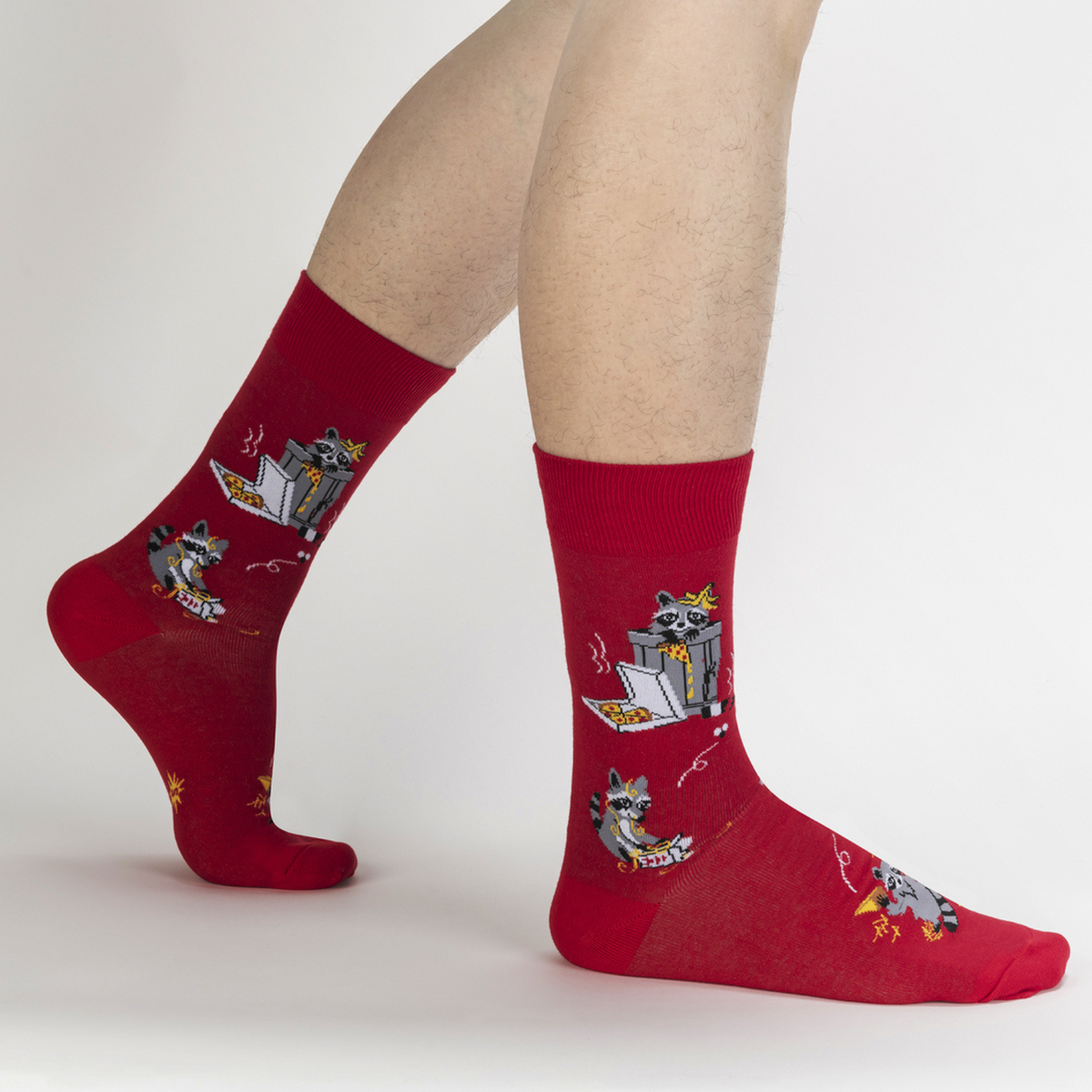 Sock It To Me Trash Panda men&#39;s sock featuring red crew sock with raccoons eating pizza out of the trash worn by a model seen from the side