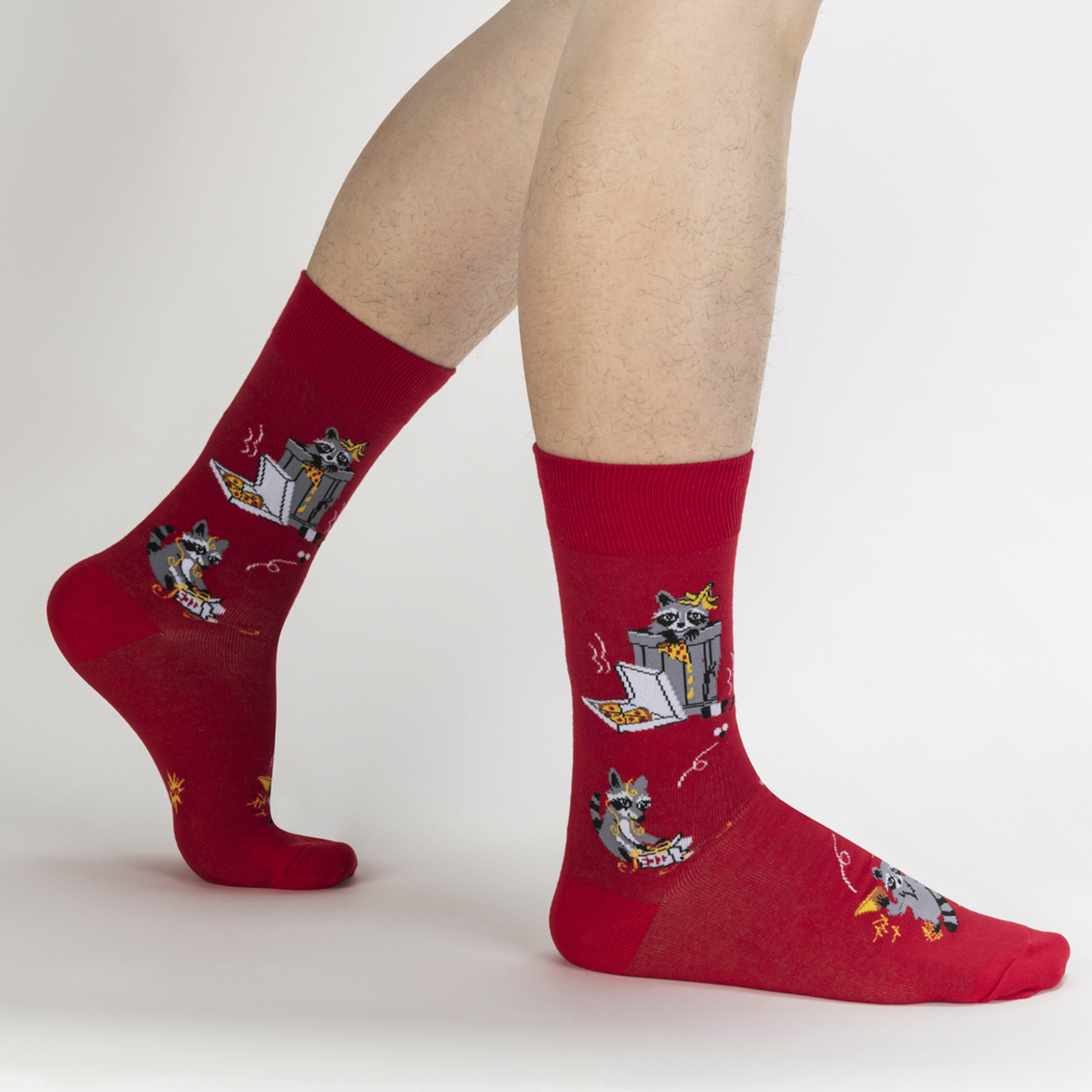 Sock It To Me Trash Panda men's sock featuring red crew sock with raccoons eating pizza out of the trash worn by a model seen from the side