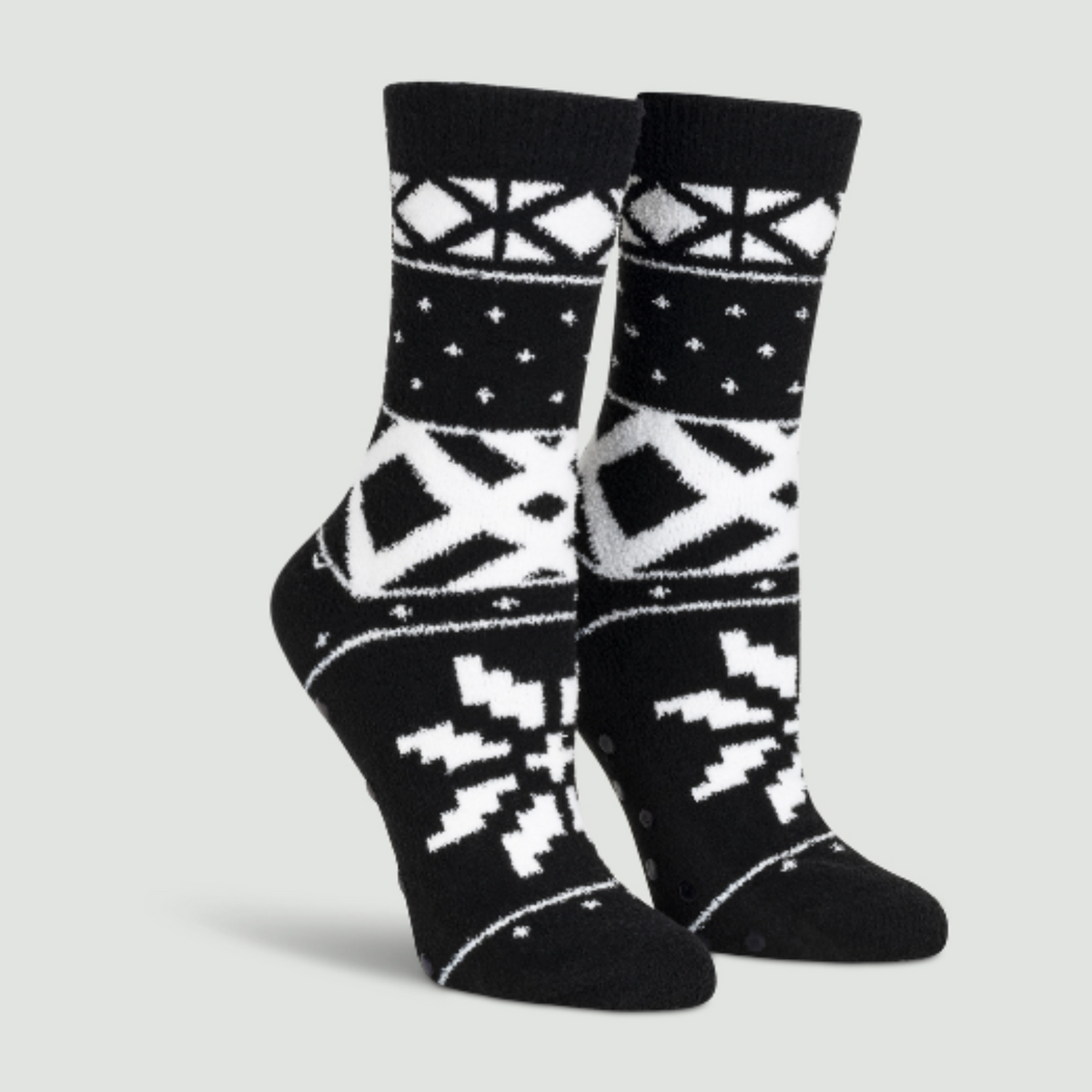 Sock It To Me You Sweater Believe It women&#39;s slipper sock featuring black fair isle pattern. Socks shown on display feet.