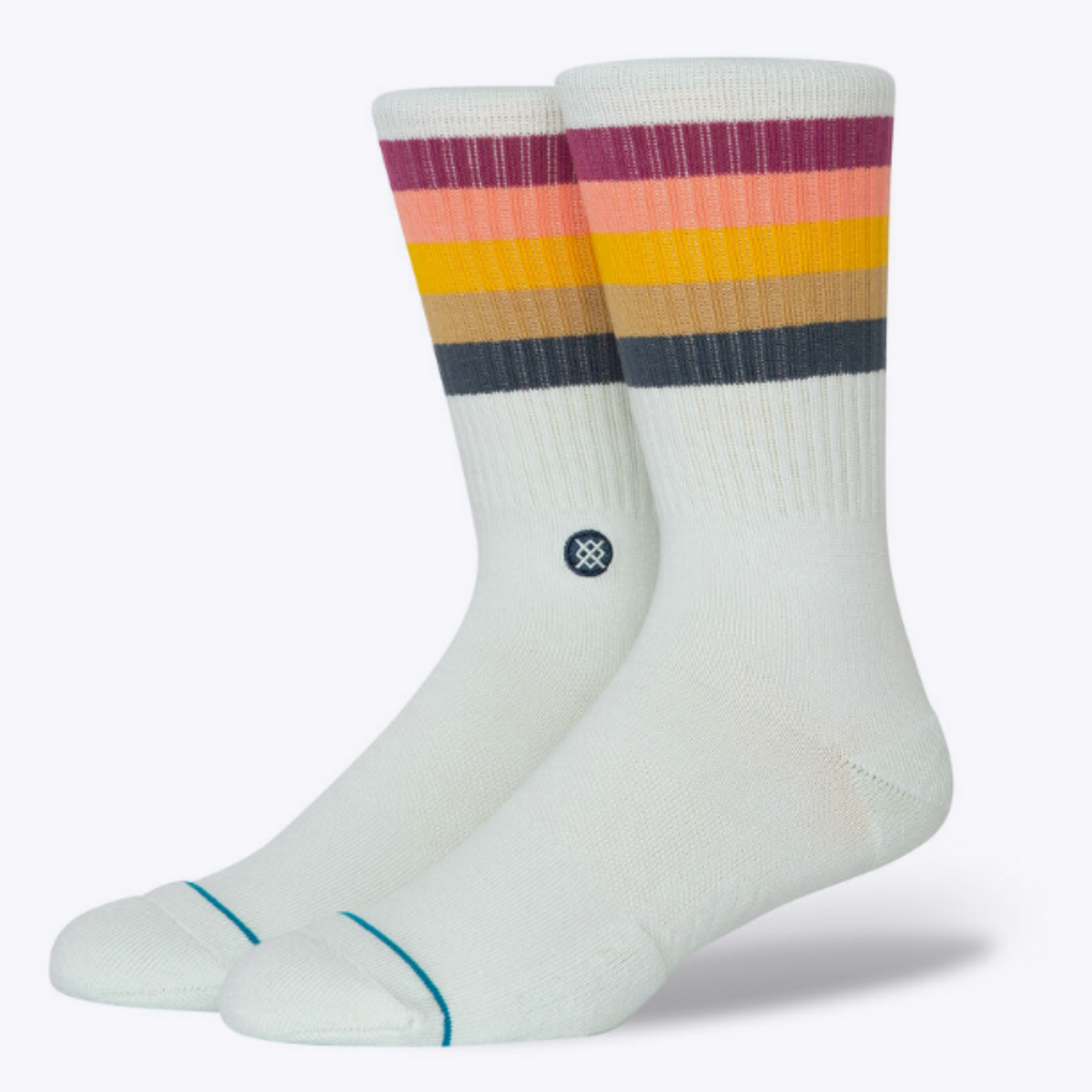 Stance Maliboo women&#39;s crew sock featuring light blue sock with cranberry, peach, tumeric, beige, and gray stripes at cuff. Socks shown on display feet. 