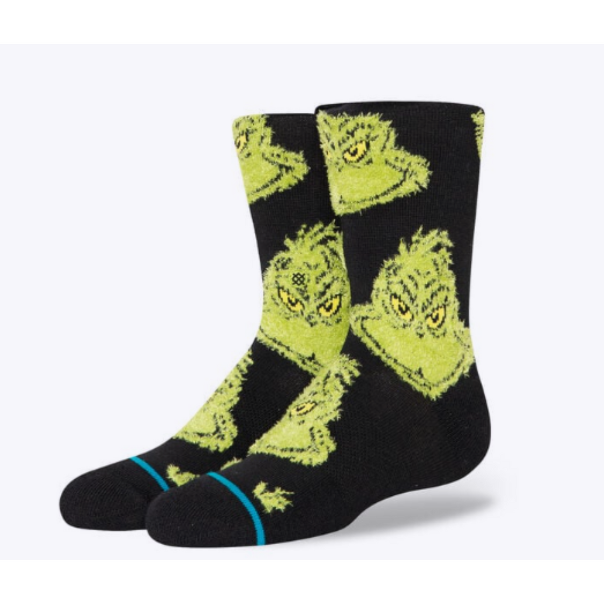 Stance The Grinch Mean One kids&#39; crew sock featuring a black sock with images of The Grinch all over. Socks shown on display feet. 
