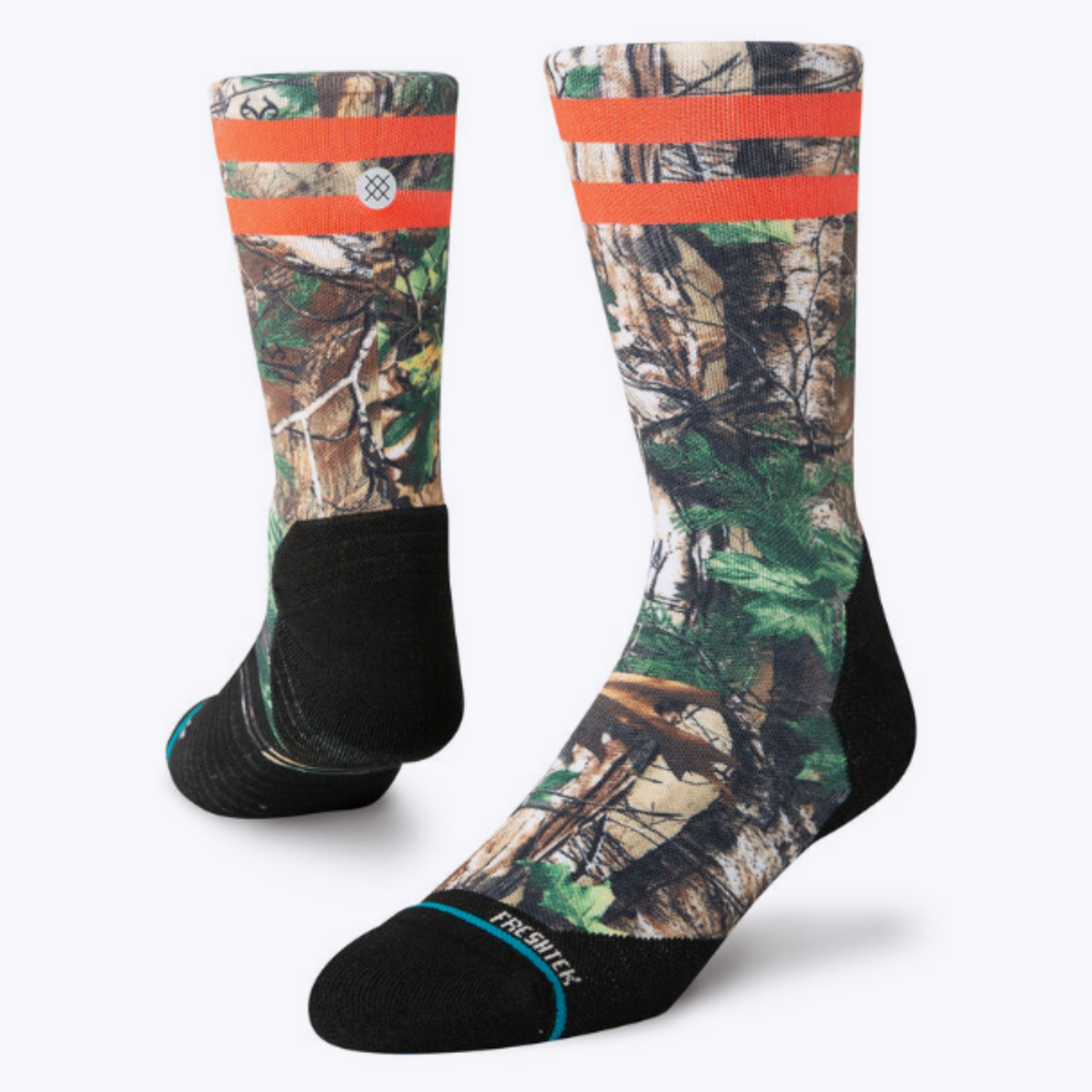 Stance Xtra Light Xtra Performance men&#39;s crew sock featuring all-over camouflage pattern and two orange stripes at top. Socks shown on display feet. 