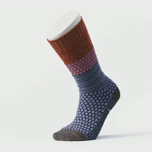 Video of Smartwool Popcorn Cable Crew women's sock featuring rust colored cuff, and blue and lavender pattern on rest of sock. Sock on display foot
