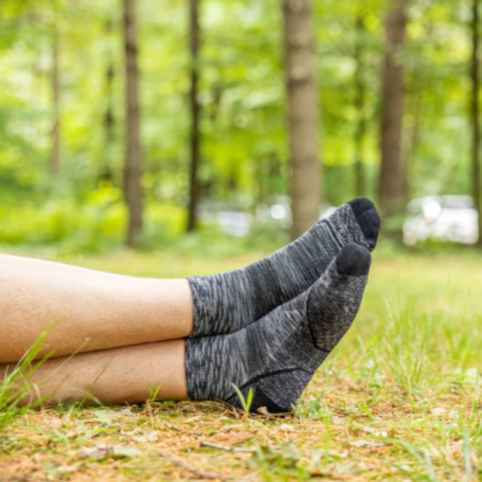 Darn Tough 1991 Quarter Height Lightweight Hike men's sock in space gray on a model showing just the socks in feet in the woods