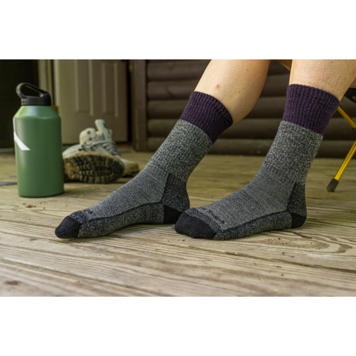 Darn Tough 1983 Scout Midweight Hiking Boot women&#39;s sock featuring grey sock with purple cuff worn by model