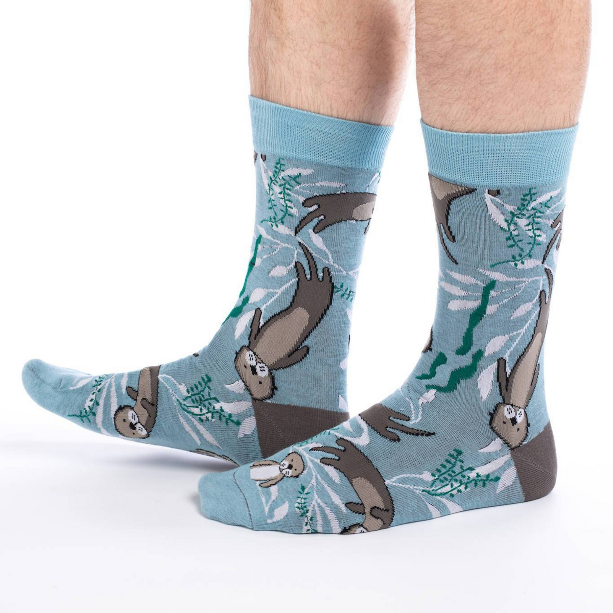 Good Luck Sock Sea Otter men&#39;s sock featuring blue sock with otters swimming with kelp on model