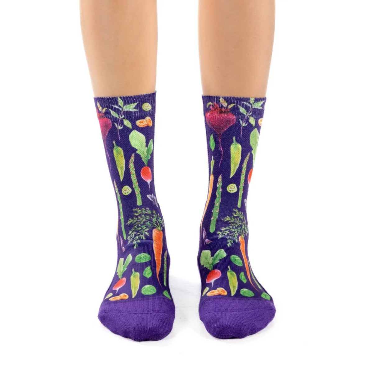 Good Luck Sock Veggies women&#39;s sock featuring purple crew sock with beets, asparagus, carrots, radishes and more on model&#39;s feet