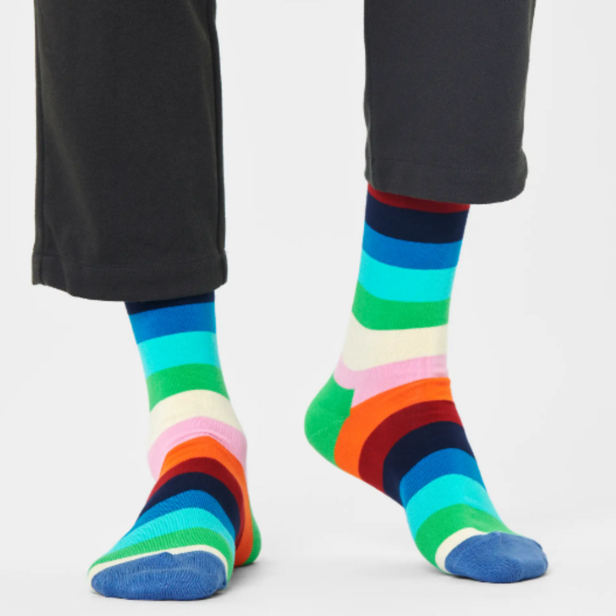 Happy Socks Stripe Green men&#39;s sock on model close up showing multi-colored stripe socks with blue toe and green heel