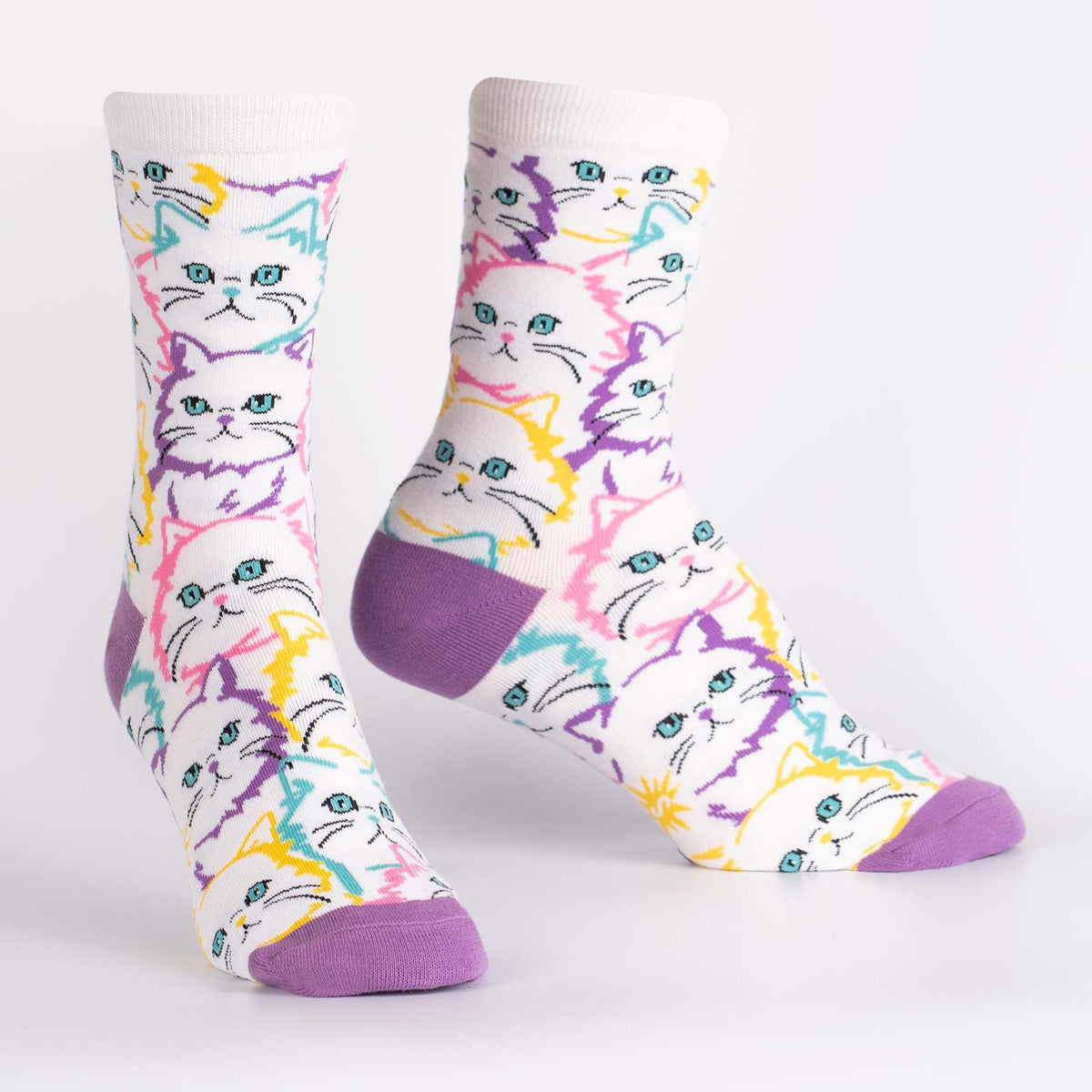Sock It To Me Fur Real women&#39;s crew sock featuring white sock with lavender heel and toe with white cats outlined in pastel colors. Socks shown on display feet. 