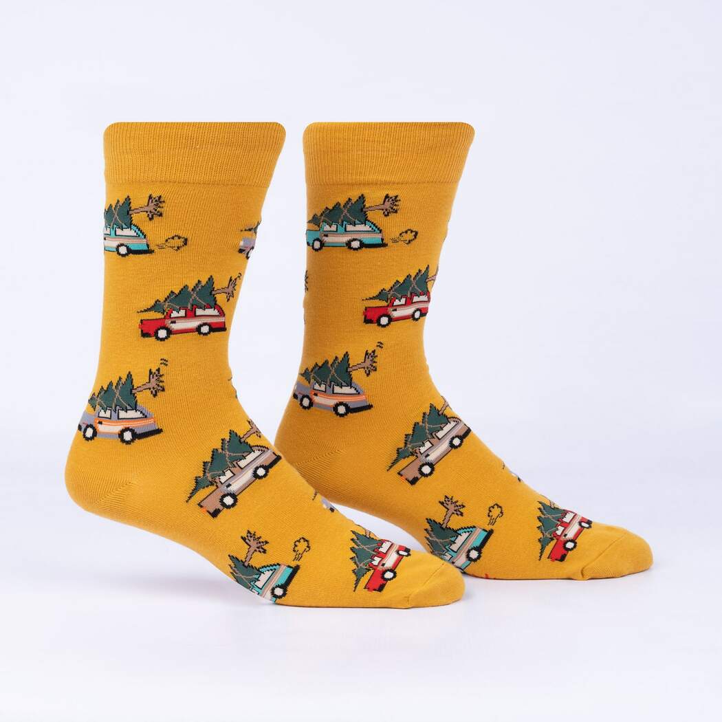 Sock It To Me Little Full, Lotta Sap men&#39;s crew sock featuring mustard yellow sock with images of station wagons with christmas trees tied to the top. Socks shown on display feet from the side. 