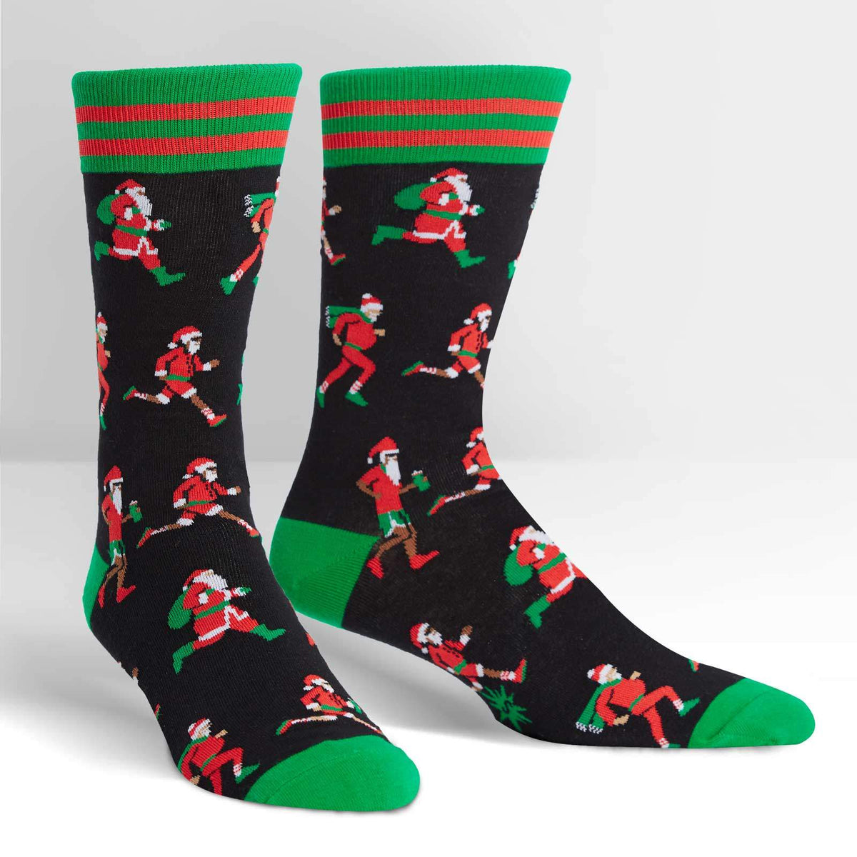 Sock It To Me Santa Run men&#39;s crew sock featuring black sock with various Santa Clauses running. Socks shown on display feet. 