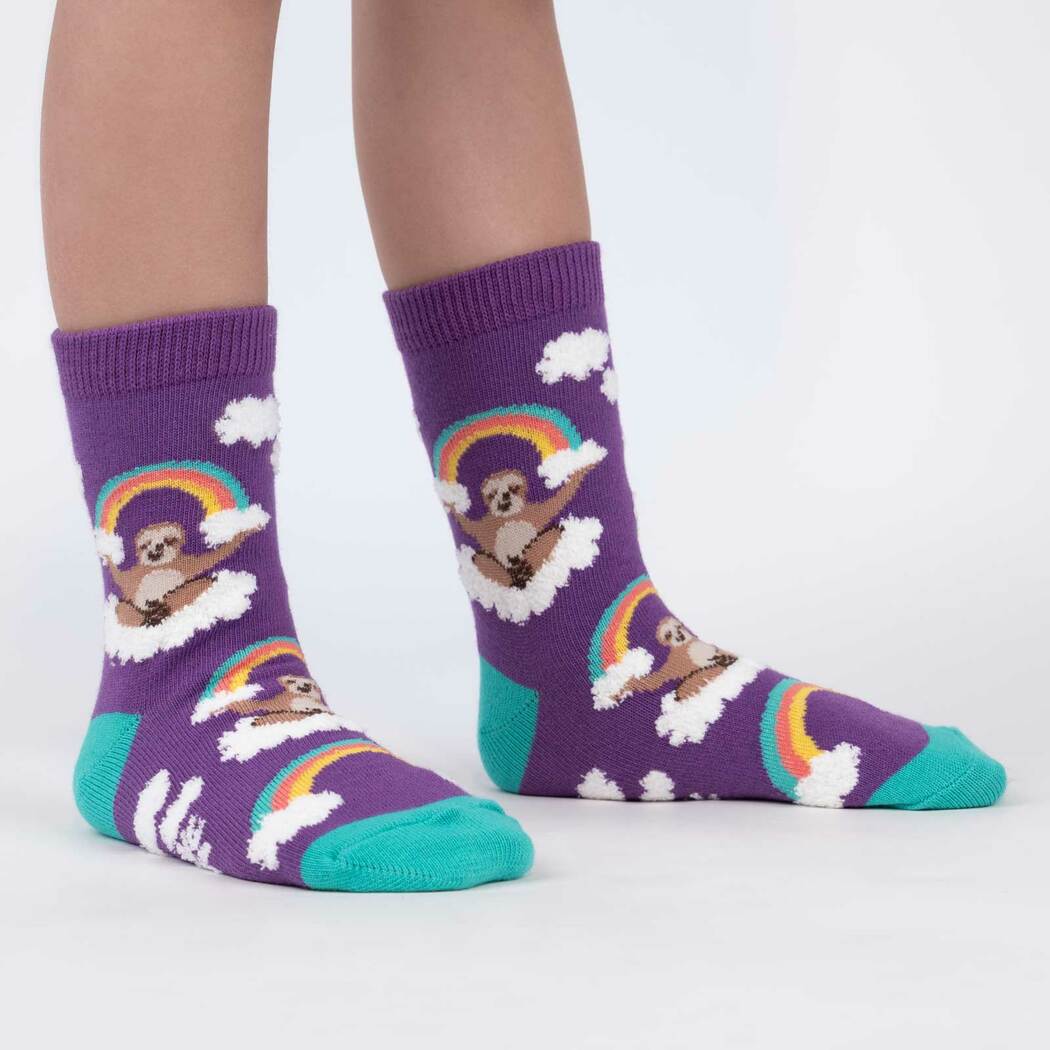 Sock It To Me purple child sock with sloth sitting on a cloud holding a rainbow