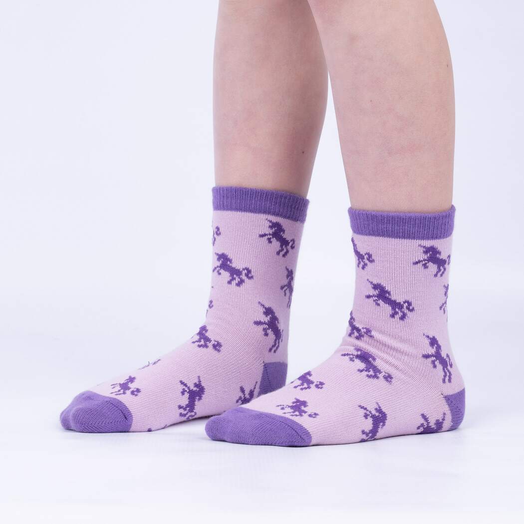 Sock It To Me Winging It 3-pack kids&#39; socks featuring lavender sock with unicorn silhouettes all over worn by model seen from the side