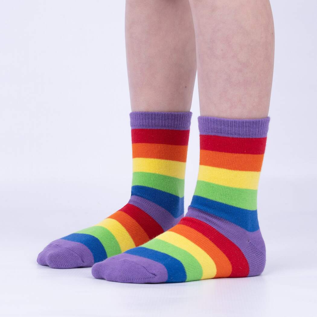 Sock It To Me Winging It 3-pack kids&#39; socks featuring rainbow stripe socks worn by model seen from the side
