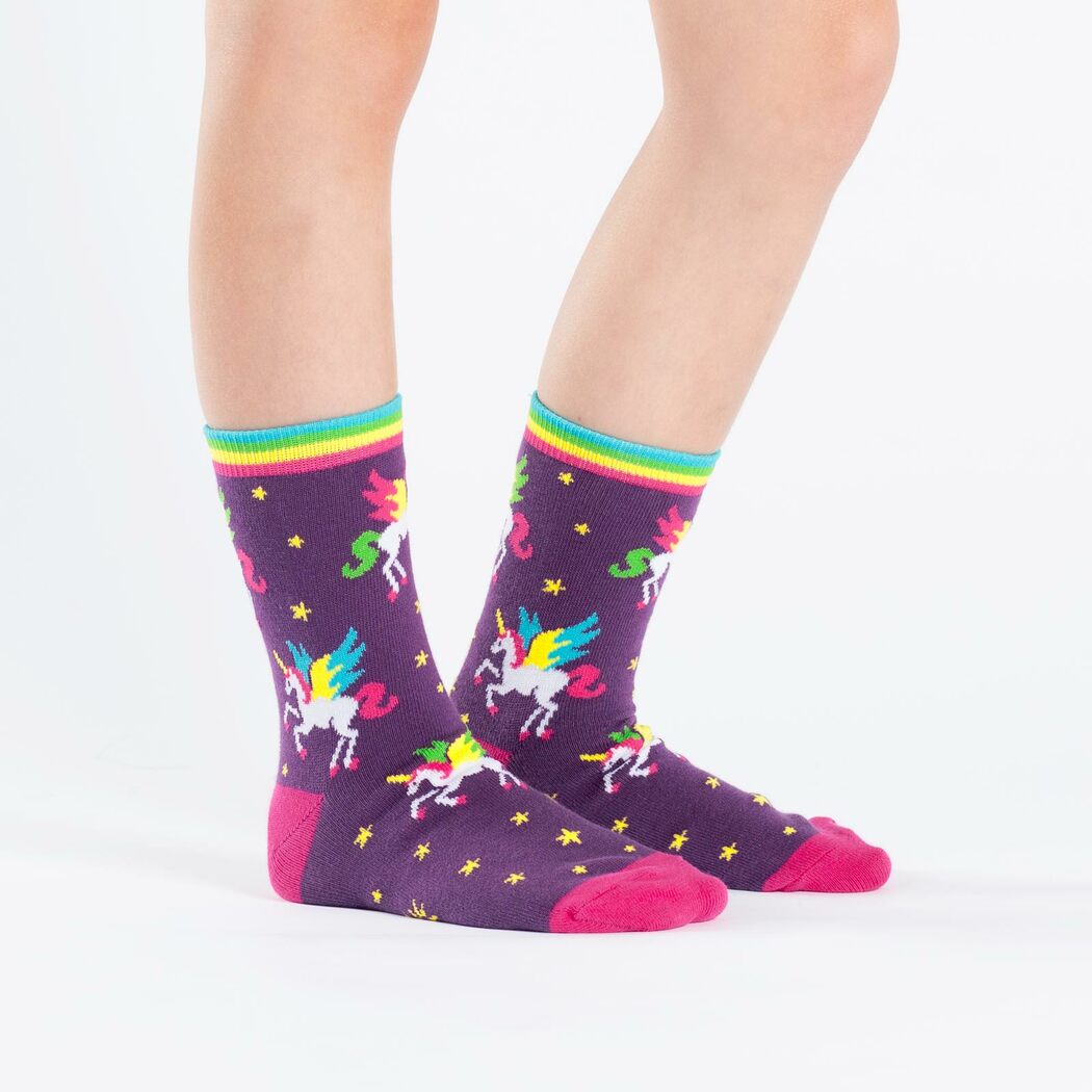 Sock It To Me Winging It 3-pack kids&#39; socks featuring purple sock with stars and unicorn Pegasus all over worn by model seen from the side