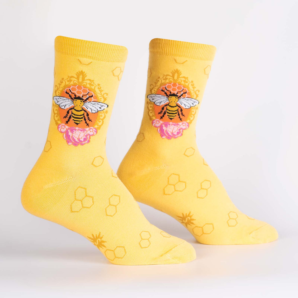 Sock It To Me Queen Bee women&#39;s crew sock featuring yellow sock with large queen bee. Socks shown on display feet. 