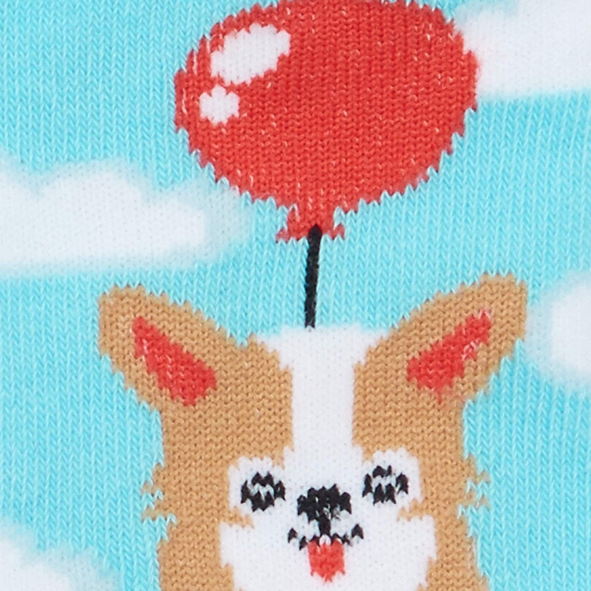 Detail of Corgi dog on Sock It To Me Pup, Pup and Away women&#39;s and kid&#39;s socksSock It To Me Pup, Pup and Away women&#39;s crew socks featuring light blue socks with clouds all over and a Corgi dog floating by a red balloon, socks show front and back of Corgi dog. 