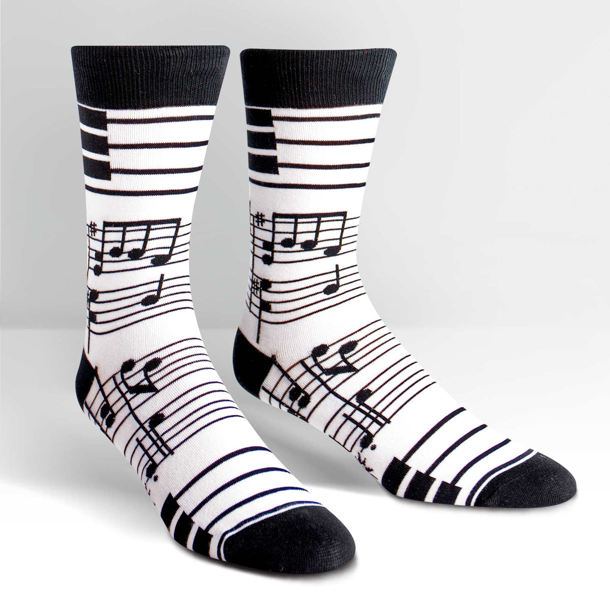 Sock it to Me Foot Notes men&#39;s crew high sock featuring white sock with black musical notes all over on display feet