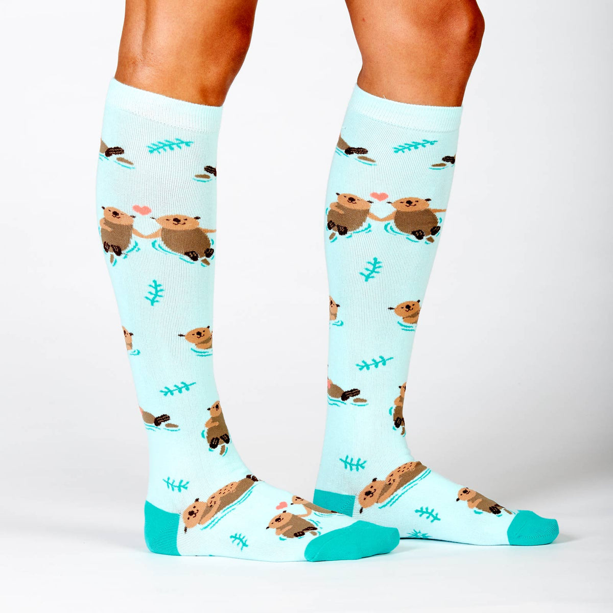 Sock It To Me My Otter Half women&#39;s socks on model showing otters in ocean 