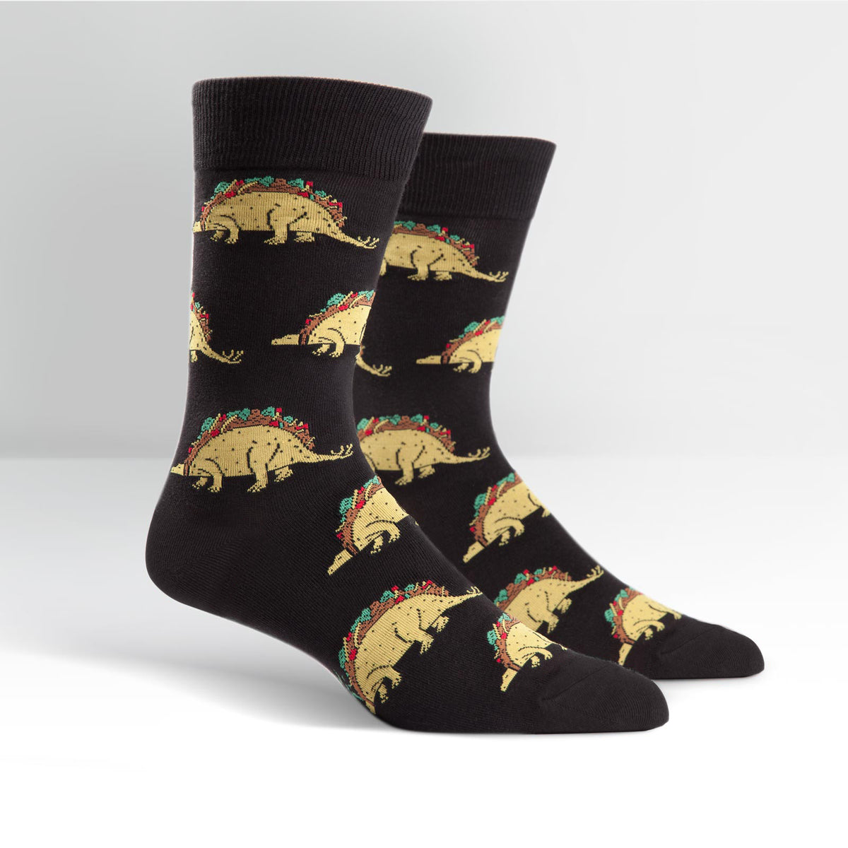 Sock It To Me black men&#39;s crew sock Tacosaurus featuring taco-dinosaurs all over on display feet seen from side